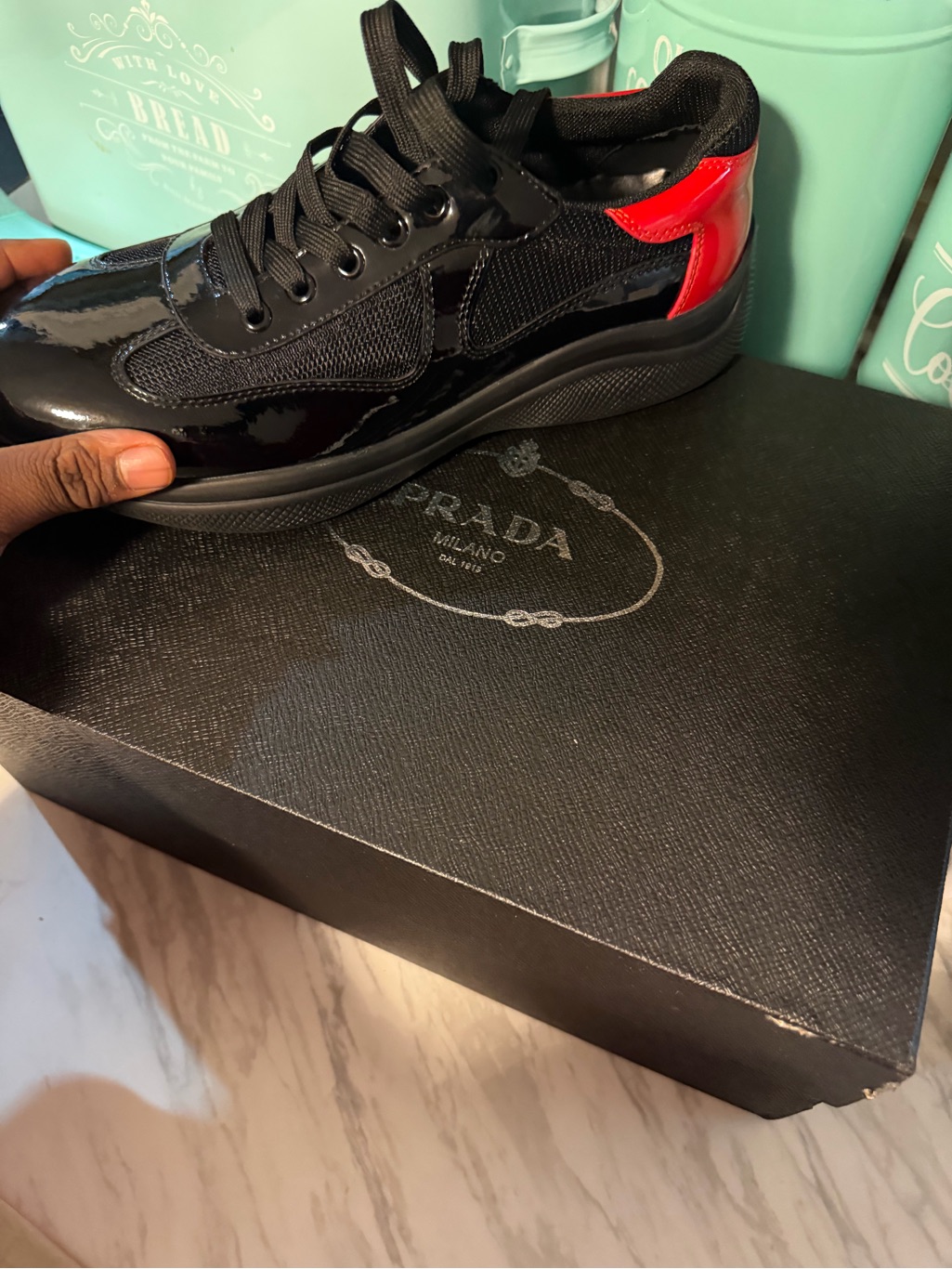 Prada Black Patent Low-Top Sneakers With Red Heel Tab